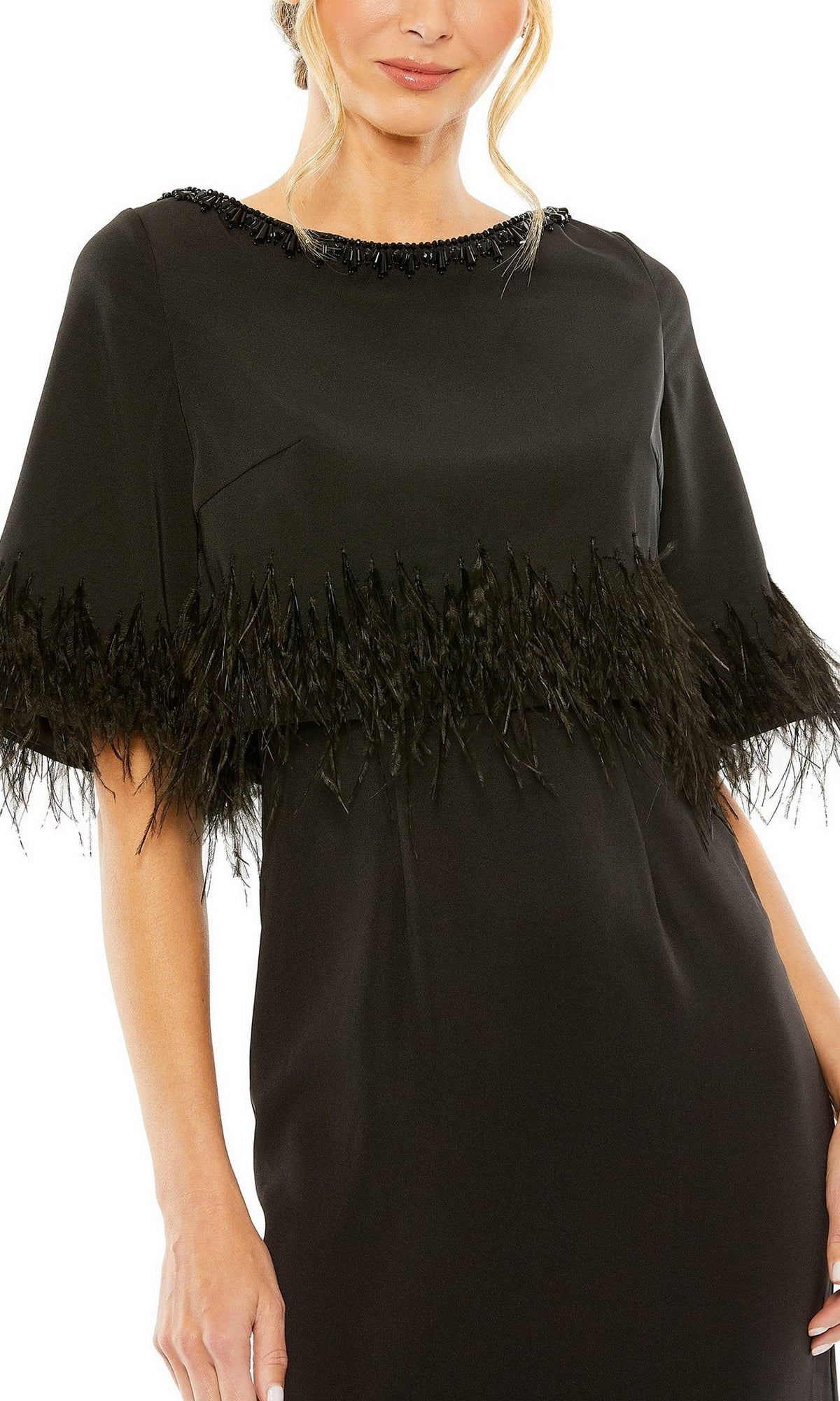 A person wears the Mac Duggal 11787 short-sleeve black formal dress, featuring feather-trimmed sleeves and chest detail, standing against a white background.